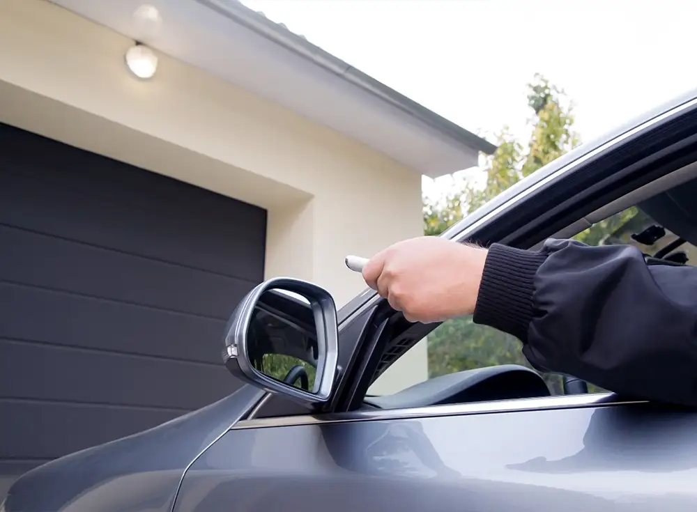 homeowner trying to open their garage door with a remote