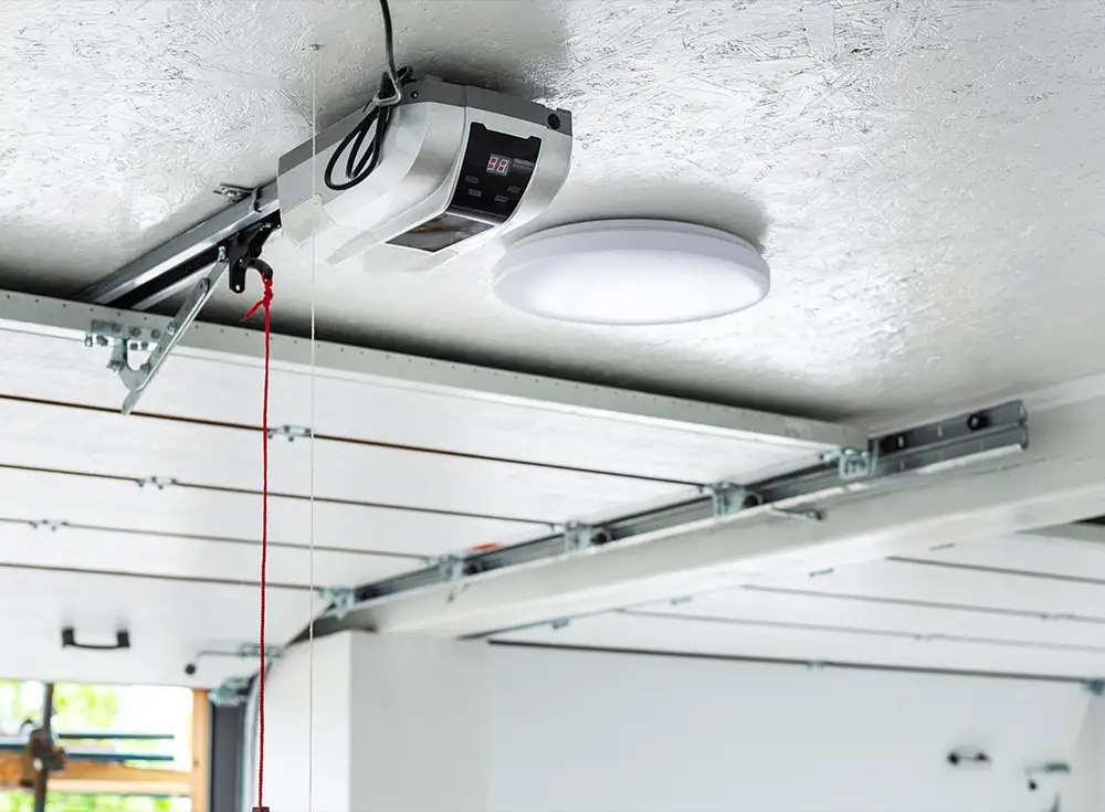 view of an opened garage door and an opener